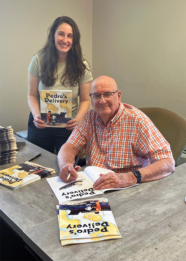 Mark signing copies of Pedro's Delivery
