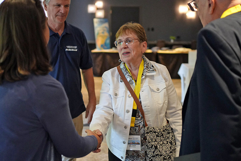 Lynn-web800 Lynn greeting an attendee